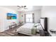 Cozy bedroom with a large TV, floral curtains, and a comfortable bed with patterned linens at 11539 Tangle Branch Ln, Gibsonton, FL 33534