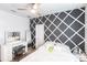 Bedroom featuring a decorative accent wall, a ceiling fan, a vanity and ample light at 11539 Tangle Branch Ln, Gibsonton, FL 33534