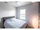 Neutral bedroom with a ceiling fan and a large window providing natural light at 11539 Tangle Branch Ln, Gibsonton, FL 33534