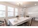 Cozy dining area featuring a traditional table setting, ample natural light, and neutral decor at 11539 Tangle Branch Ln, Gibsonton, FL 33534
