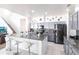 Well-lit kitchen featuring granite counters, stainless steel appliances, tile floors, a large island with seating, and stylish cabinetry at 11539 Tangle Branch Ln, Gibsonton, FL 33534