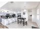Well-lit kitchen featuring granite counters, stainless steel appliances, tile floors, a large island with seating, and stylish cabinetry at 11539 Tangle Branch Ln, Gibsonton, FL 33534