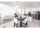 Open-concept kitchen and living area with a central island, gray cabinets, and a sleek black dining set at 11539 Tangle Branch Ln, Gibsonton, FL 33534