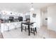Bright kitchen featuring gray cabinets, a central island, and a breakfast nook with a modern table and chairs at 11539 Tangle Branch Ln, Gibsonton, FL 33534