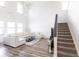 Bright living room boasting high ceilings, hardwood floors, contemporary furnishings, and a staircase leading to the second floor at 11539 Tangle Branch Ln, Gibsonton, FL 33534