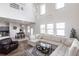 Bright living room boasting high ceilings, hardwood floors, contemporary furnishings, and a staircase leading to the second floor at 11539 Tangle Branch Ln, Gibsonton, FL 33534