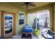 Relax on the screened porch with comfortable seating, a ceiling fan, and a view of the backyard at 11539 Tangle Branch Ln, Gibsonton, FL 33534
