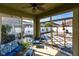 Enjoy this screened porch with patio furniture and views of the patterned stone backyard at 11539 Tangle Branch Ln, Gibsonton, FL 33534