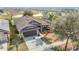 An elevated view of the house showcasing its roofline, landscaping, and proximity to a scenic pond at 12222 Legacy Bright St, Riverview, FL 33578