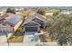 An elevated view of the house showcasing its roofline, landscaping, and proximity to a scenic pond at 12222 Legacy Bright St, Riverview, FL 33578