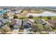 Aerial view showcasing home's roof, landscaping, and neighborhood pond in a Gathering-friendly community at 12222 Legacy Bright St, Riverview, FL 33578