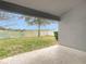 This backyard features a partial view of a pond and a white picket fence at 12222 Legacy Bright St, Riverview, FL 33578