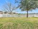Well-maintained backyard featuring a manicured lawn and a charming white picket fence at 12222 Legacy Bright St, Riverview, FL 33578