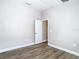 A bright bedroom features modern wood-look floors and neutral paint, creating a calming atmosphere at 12222 Legacy Bright St, Riverview, FL 33578