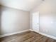 A bright bedroom features modern wood-look floors and neutral paint, creating a calming atmosphere at 12222 Legacy Bright St, Riverview, FL 33578
