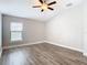 This bedroom features beautiful wood-look flooring and a ceiling fan at 12222 Legacy Bright St, Riverview, FL 33578