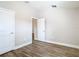 A bright bedroom features modern wood-look floors and neutral paint, creating a calming atmosphere at 12222 Legacy Bright St, Riverview, FL 33578