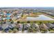Community aerial showcasing the neighborhood layout, nearby pond, and the arrangement of homes at 12222 Legacy Bright St, Riverview, FL 33578