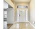 Bright foyer featuring tile flooring, an ornate front door with sidelights, and an adjacent doorway at 12222 Legacy Bright St, Riverview, FL 33578