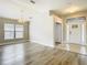 Bright open-concept foyer with tile flooring, a decorative front door, and view into the spacious dining area at 12222 Legacy Bright St, Riverview, FL 33578