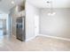 Bright dining space adjacent to kitchen with stainless refrigerator at 12222 Legacy Bright St, Riverview, FL 33578
