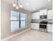 Bright kitchen and dining area with stainless appliances and ample cabinet space at 12222 Legacy Bright St, Riverview, FL 33578