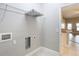 This laundry room features tile flooring, a shelf, and hookups for a washer and dryer at 12222 Legacy Bright St, Riverview, FL 33578