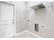 This laundry room offers tile flooring, a shelf, and hookups for a washer and dryer at 12222 Legacy Bright St, Riverview, FL 33578