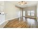 Open-concept living room with hardwood floors, fan and neutral paint throughout at 12222 Legacy Bright St, Riverview, FL 33578