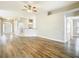 Open-concept living room with hardwood floors, fan and neutral paint throughout at 12222 Legacy Bright St, Riverview, FL 33578