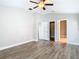 A bright main bedroom features modern wood-look floors, a ceiling fan and neutral paint at 12222 Legacy Bright St, Riverview, FL 33578