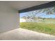 View of the patio overlooking the spacious backyard with a white picket fence at 12222 Legacy Bright St, Riverview, FL 33578