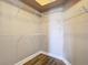 This walk-in closet features wire shelving and wood-look flooring at 12222 Legacy Bright St, Riverview, FL 33578