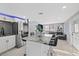 Open-concept kitchen island with seating and stainless steel refrigerator in a brightly lit home at 1315 E Dr Martin Luther King Jr Blvd, Plant City, FL 33563