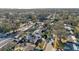 Scenic aerial view of the neighborhood showcasing houses, mature trees, and street at 13330 88Th Pl, Seminole, FL 33776