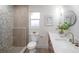 Modern bathroom showcasing a double vanity, sleek fixtures, neutral tiling, and a glass-enclosed shower at 13330 88Th Pl, Seminole, FL 33776