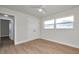 This bedroom features sleek hardwood floors, a modern ceiling fan, and double door closet at 13330 88Th Pl, Seminole, FL 33776