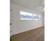 Well-lit bedroom highlighting wood-look floors, a window, and a ceiling fan at 13330 88Th Pl, Seminole, FL 33776