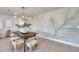 Well-appointed dining area featuring a designer light fixture, comfortable seating, and stylish modern decor at 13330 88Th Pl, Seminole, FL 33776