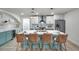 A stunning kitchen with a large island, wicker stools, modern appliances, and light green cabinets at 13330 88Th Pl, Seminole, FL 33776