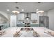 Modern kitchen with marble counters, stainless steel appliances, a stylish tile backsplash, and designer lighting at 13330 88Th Pl, Seminole, FL 33776