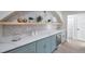 Charming kitchen displaying elegant decor, light green cabinetry, marble countertops, and a built-in wine cooler at 13330 88Th Pl, Seminole, FL 33776
