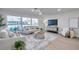Sunlit living room with large windows, stylish decor, and hardwood floors, creating a welcoming space at 13330 88Th Pl, Seminole, FL 33776