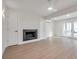 Open concept living area with modern fireplace, mini-split A/C and hardwood floors at 13330 88Th Pl, Seminole, FL 33776