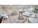 Open-concept living area flowing into the dining area, adorned with a decorative mural and modern furnishings at 13330 88Th Pl, Seminole, FL 33776