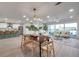 Spacious open floor plan with a dining table, a kitchen bar, and a comfortable living area with abundant natural light at 13330 88Th Pl, Seminole, FL 33776