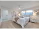 Bright and airy main bedroom featuring a large window, ceiling fan, and neutral decor at 13330 88Th Pl, Seminole, FL 33776