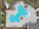 Aerial view of a uniquely shaped community pool with ample seating and lounging areas at 14413 Woodland Spur Dr, Lithia, FL 33547