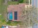 Overhead shot of home with a large screened pool, solar panels, and inviting outdoor living space at 1734 Kinsmere Dr, Trinity, FL 34655