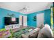 Inviting living room with bright blue walls, fun decorations, and comfortable seating arrangement at 1734 Kinsmere Dr, Trinity, FL 34655